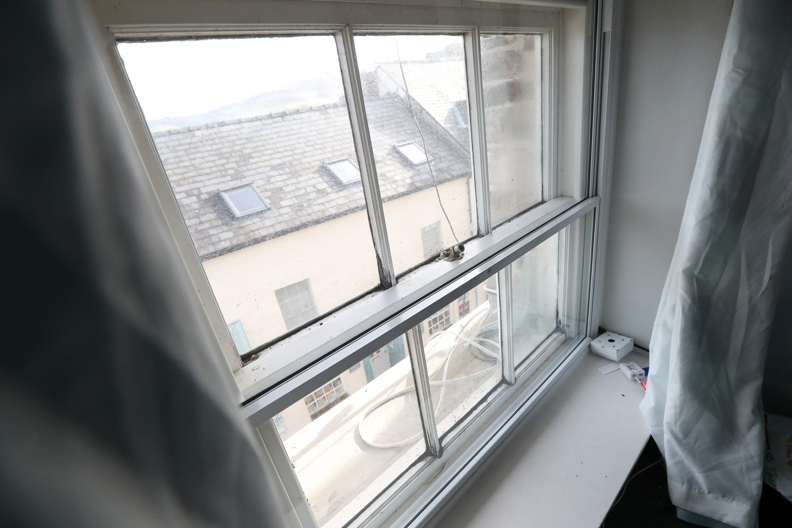 Vertical sliding secondary glazing